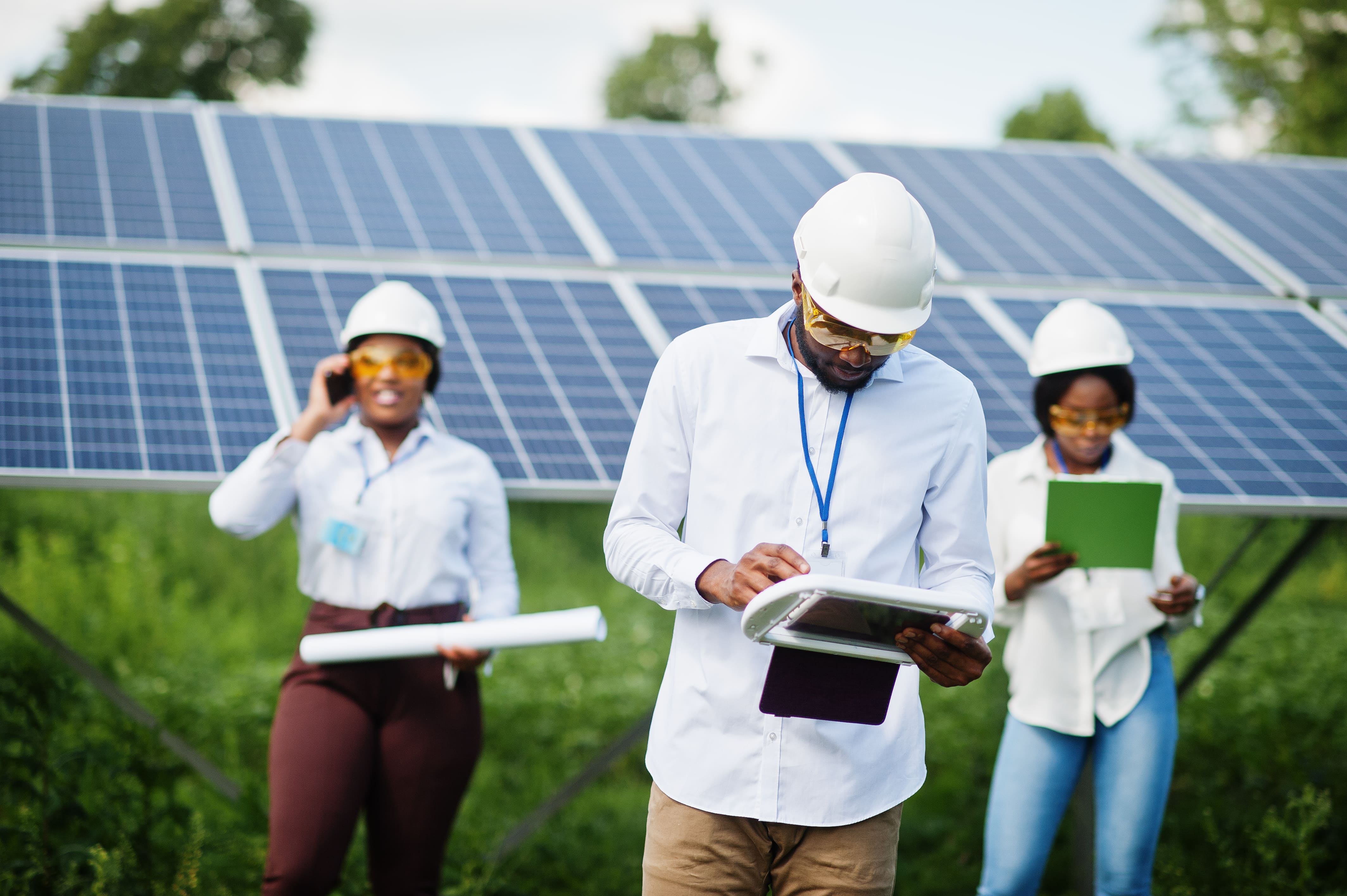 african-american-technician-checks-maintenance-solar-panels-group-three-black-engineers-meeting-solar-station (1)